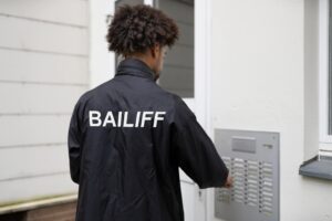 bailiff knocking on the door