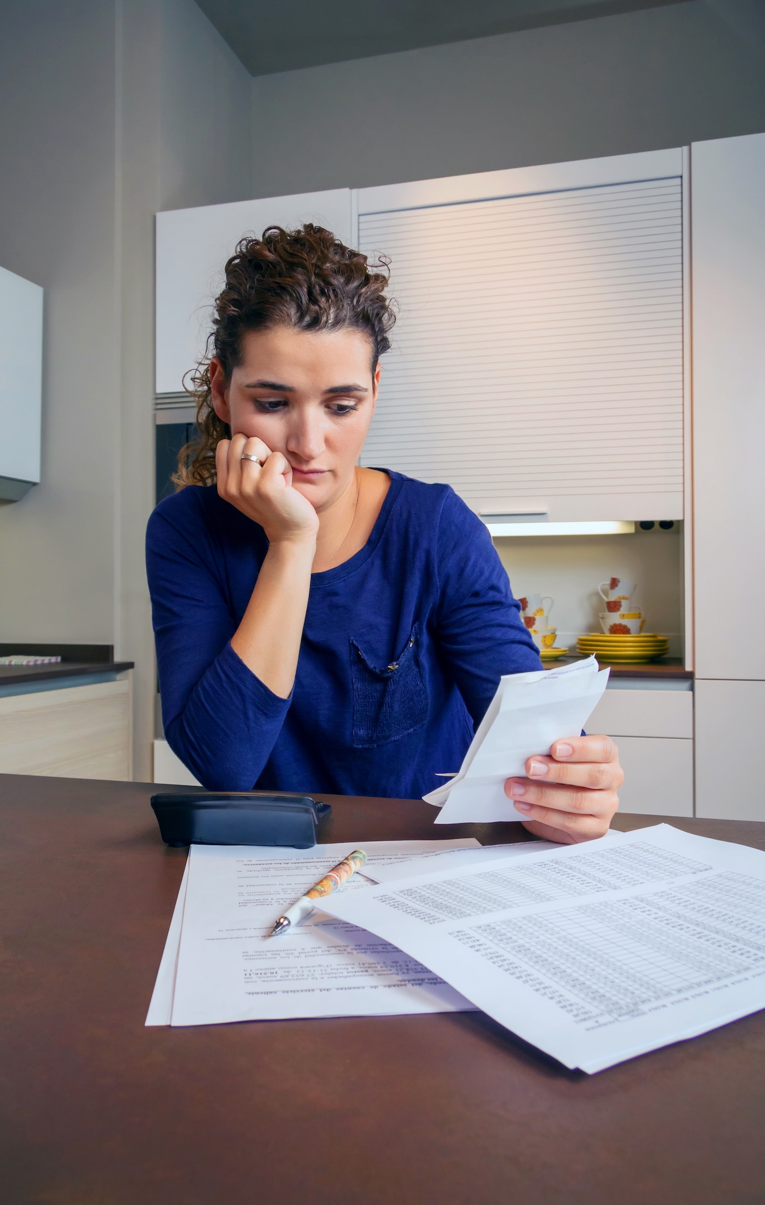 A woman looking at her debts and letters from Equita